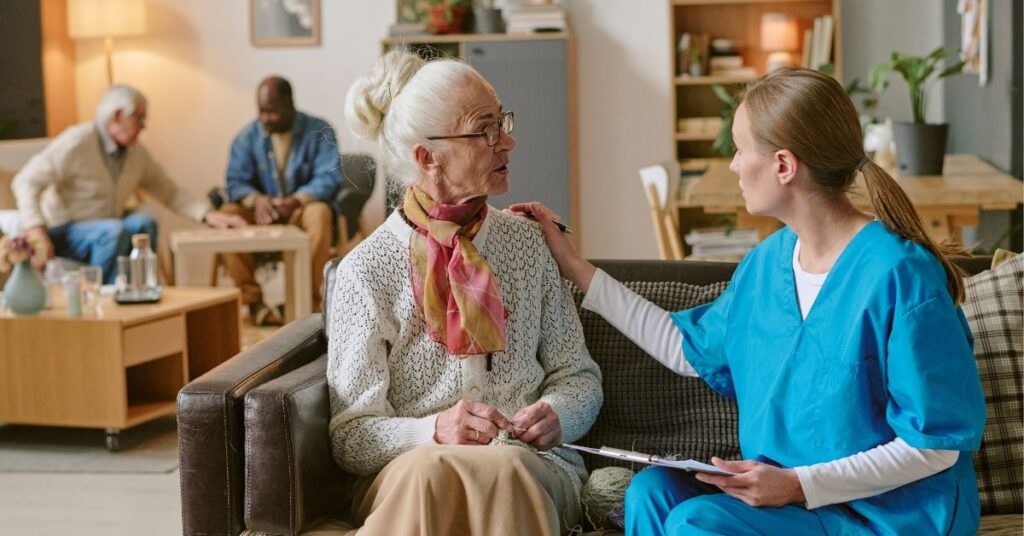 a senior lady talking with her caregiver at memory care