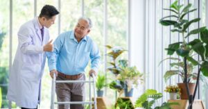 a senior men walking next to a doctor