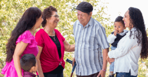 a senior couple sharing with their family at assisted living community