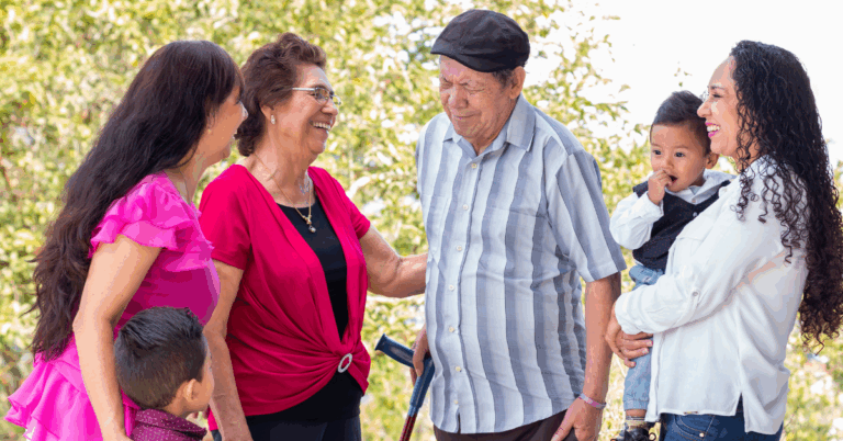 a senior couple sharing with their family at assisted living community