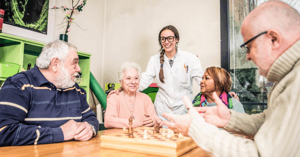 a group of seniors playing chest at assisted living communty